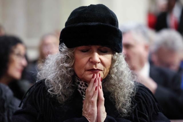A woman prays as she waits for the start of an installation Mass for Ronald Hicks to become the 11th Archbishop of New York, succeeding Cardinal Timothy Dolan, at St. Patrick’s Cathedral in New York, on February 6, 2026. (Photo by ANGELA WEISS / AFP)