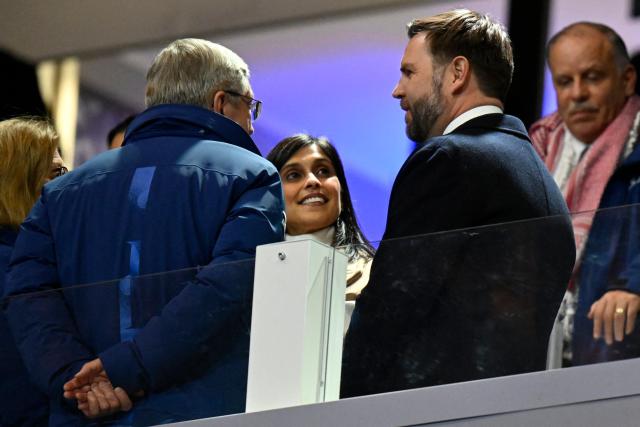 (From L) Former IOC president Thomas Bach , US second lady Usha Vance and US Vice President JD Vance talk in the tribune prior to the start of the opening ceremony of the Milano Cortina 2026 Winter Olympic Games at the San Siro stadium in Milan, northern Italy, on February 6, 2026. (Photo by Alexander NEMENOV / AFP)
