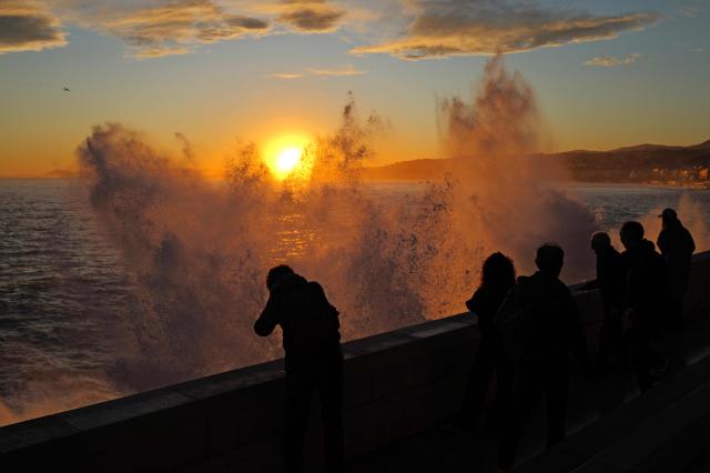 A man takes photographs of big waves at sunset on the French riviera city of Nice, on February 6, 2026. (Photo by Valery HACHE / AFP)