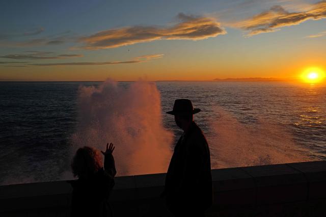 TOPSHOT - A man looks at big waves at sunset on the French riviera city of Nice, on February 6, 2026. (Photo by Valery HACHE / AFP)
