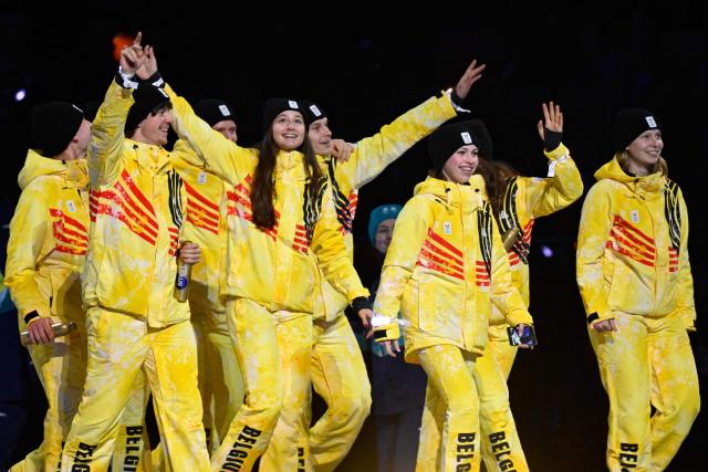 Belgium's Nina Pinzarrone (2ndR), Belgium's Tineke den Dulk (R) and fellow Belgian athletes parade during the opening ceremony of the Milano Cortina 2026 Winter Olympic Games at the San Siro stadium in Milan, northern Italy, on February 6, 2026. (Photo by Alexander NEMENOV / AFP)