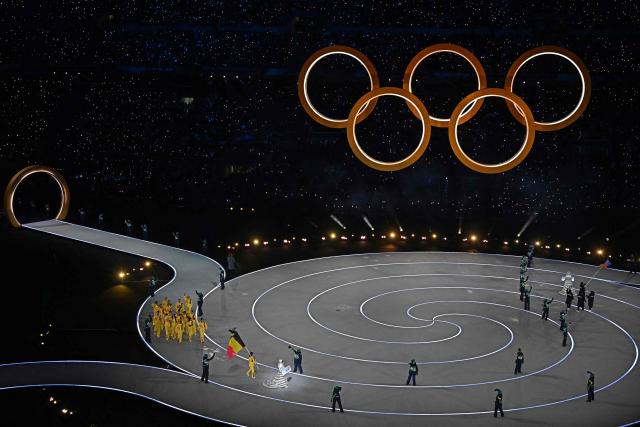 Belgium's flag bearer Hanne Desmet parades with other athletes during the opening ceremony of the Milano Cortina 2026 Winter Olympic Games at the San Siro stadium in Milan, northern Italy, on February 6, 2026. (Photo by Gabriel BOUYS / AFP)