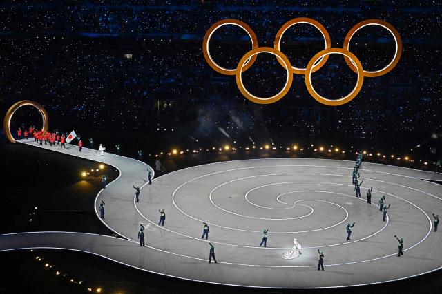 Japan's flag bearer Wataru Morishige parades with other athletes during the opening ceremony of the Milano Cortina 2026 Winter Olympic Games at the San Siro stadium in Milan, northern Italy, on February 6, 2026. (Photo by Gabriel BOUYS / AFP)