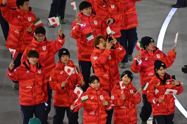 Team Japan athletes parade during the opening ceremony of the Milano Cortina 2026 Winter Olympic Games at the San Siro stadium in Milan, northern Italy, on February 6, 2026. (Photo by Piero CRUCIATTI / AFP)