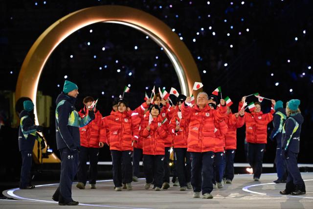 Japan's Hana Noake (L), Japan's Rio Yamada (C) and fellow athletes parade during the opening ceremony of the Milano Cortina 2026 Winter Olympic Games at the San Siro stadium in Milan, northern Italy, on February 6, 2026. (Photo by WANG Zhao / AFP)