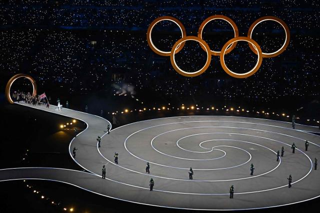 Britain's flag bearer Lilah Fear parades with other athletes during the opening ceremony of the Milano Cortina 2026 Winter Olympic Games at the San Siro stadium in Milan, northern Italy, on February 6, 2026. (Photo by Gabriel BOUYS / AFP)