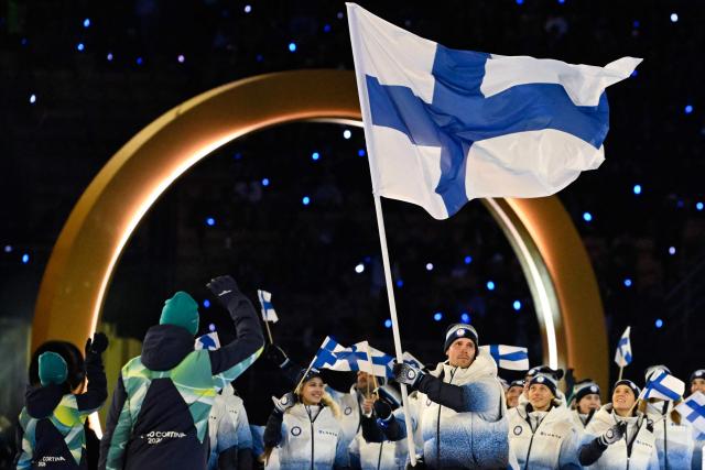 Finland's flag bearer Mikko Lehtonen and fellow athletes parade during the opening ceremony of the Milano Cortina 2026 Winter Olympic Games at the San Siro stadium in Milan, northern Italy, on February 6, 2026. (Photo by WANG Zhao / AFP)