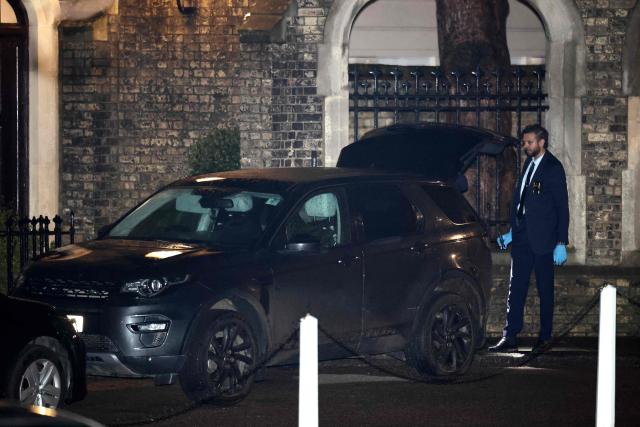 A police officer searches a car, parked outside the residence of Former UK ambassador to the United States, Peter Mandelson, in central London on February 6, 2025. UK police probing Mandelson were searching two properties on February 6, 2026, London's Metropolitan Police said, following fresh revelations in the Epstein files. The searches came as Prime Minister Keir Starmer faces intense scrutiny over his decision to appoint Mandelson as the country's US envoy despite his association with convicted US sex offender Jeffrey Epstein. (Photo by Henry NICHOLLS / AFP)