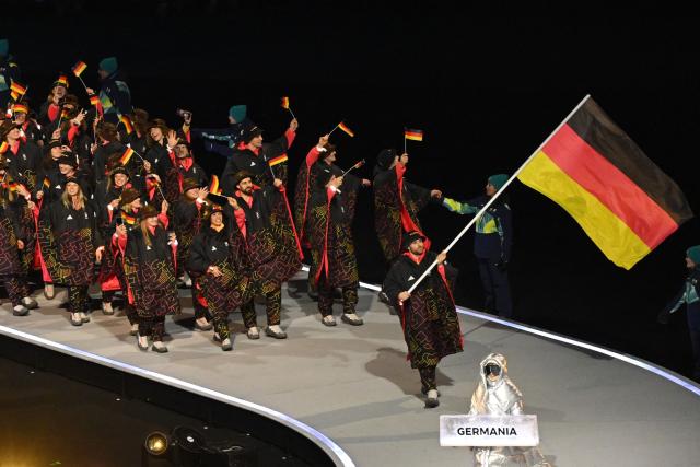 Germany's flag bearer Leon Draisaitl parades with other athletes during the opening ceremony of the Milano Cortina 2026 Winter Olympic Games at the San Siro stadium in Milan, northern Italy, on February 6, 2026. (Photo by Piero CRUCIATTI / AFP)