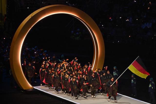Germany's flag bearer Leon Draisaitl parades with other athletes during the opening ceremony of the Milano Cortina 2026 Winter Olympic Games at the San Siro stadium in Milan, northern Italy, on February 6, 2026. (Photo by Piero CRUCIATTI / AFP)