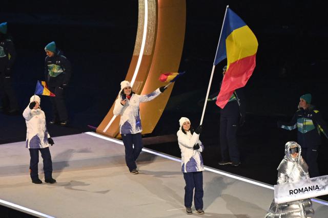 Romania's flag bearer Julia Sauter parades with other athletes during the opening ceremony of the Milano Cortina 2026 Winter Olympic Games at the San Siro stadium in Milan, northern Italy, on February 6, 2026. (Photo by Piero CRUCIATTI / AFP)