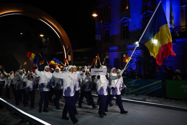 Romania's flag bearer Mihai Cristian Tentea (R)  parades with members of the delegation during the opening ceremony of the Milano Cortina 2026 Winter Olympic Games in Cortina d'Ampezzo, northern Italy, on February 6, 2026. (Photo by FRANCK FIFE / AFP)