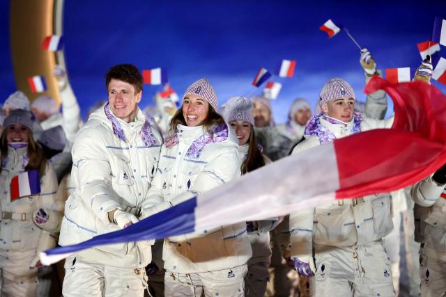 France's flag bearers Clement Noel and Chloe Trespeuch lead the team during the opening ceremony of the Milano Cortina 2026 Winter Olympic Games in Livigno, northern Italy, on February 6, 2026. (Photo by Cameron Spencer / POOL / AFP)