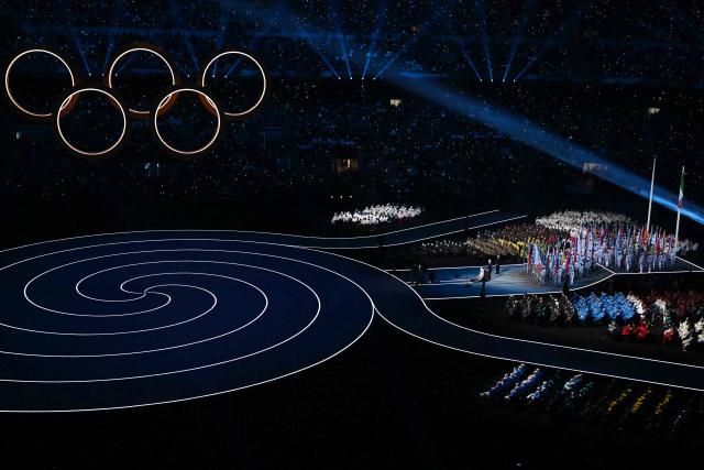 TOPSHOT - President of the Organising Committee for the 2026 Olympic and Paralympic Winter Games Giovanni Malago delivers his opening remarks during the opening ceremony of the Milano Cortina 2026 Winter Olympic Games at the San Siro stadium in Milan, northern Italy, on February 6, 2026. (Photo by Gabriel BOUYS / AFP)