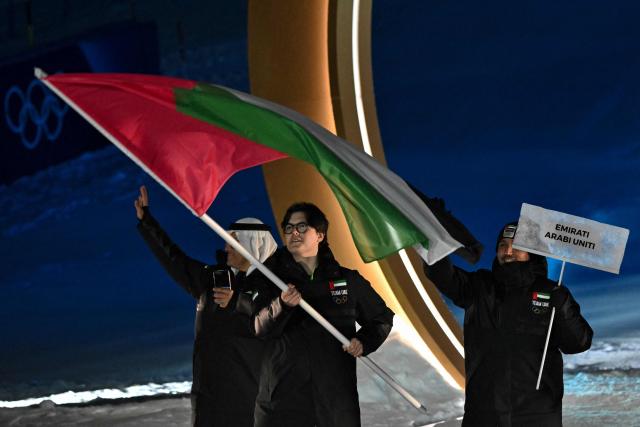 UAE's flag bearer Alexander Astridge parades during the opening ceremony of the Milano Cortina 2026 Winter Olympic Games in Livigno, northern Italy, on February 6, 2026. (Photo by Jeff PACHOUD / AFP)
