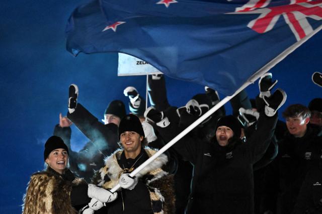 Flag bearers Zoi Sadowski-Synnott and Ben Barclay of Team New Zealand enter with the delegation during the opening ceremony of the Milano Cortina 2026 Winter Olympic Games in Livigno, northern Italy, on February 6, 2026. (Photo by Jeff PACHOUD / AFP)