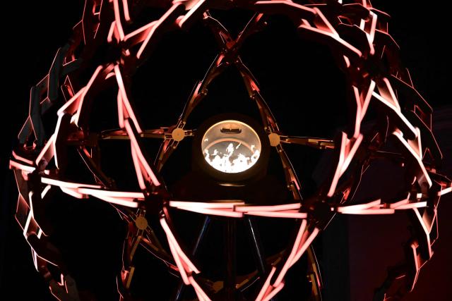 This photograph shows a view of the Olympic cauldron designed by Marco Balich during the opening ceremony of the Milano Cortina 2026 Winter Olympic Games at Piazza Angelo Dibona in Cortina d'Ampezzo, northern Italy, on February 6, 2026. (Photo by Stefano RELLANDINI / POOL / AFP)