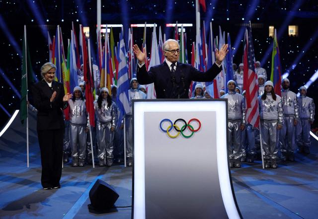 President of the Organising Committee for the 2026 Olympic and Paralympic Winter Games Giovanni Malago (C), flanked by President of the International Olympic Committee (IOC) Kirsty Coventry (R), delivers a speech during the opening ceremony of the Milano Cortina 2026 Winter Olympic Games at the San Siro stadium in Milan, northern Italy, on February 6, 2026. (Photo by Yves Herman / POOL / AFP)