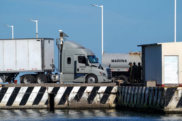 A naval supplies truck is pictured beside the Isla Holbox (BAL-02) vessel belonging to the Mexican Navy (SEMAR), intended for humanitarian aid, which is docked at Veracruz port in Veracruz, Mexico, on February 6, 2026. Mexico will ship humanitarian aid to Cuba in the coming days while continuing to negotiate with Washington on the possibility of circumventing a US oil siege, President Claudia Sheinbaum said on February 6. (Photo by Victoria Razo / AFP)