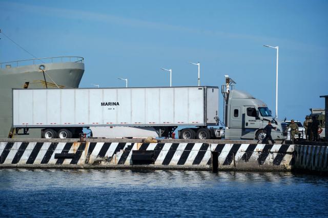 A naval supplies truck is pictured beside the Isla Holbox (BAL-02) vessel belonging to the Mexican Navy (SEMAR), intended for humanitarian aid, which is docked at Veracruz port in Veracruz, Mexico, on February 6, 2026. Mexico will ship humanitarian aid to Cuba in the coming days while continuing to negotiate with Washington on the possibility of circumventing a US oil siege, President Claudia Sheinbaum said on February 6. (Photo by Victoria Razo / AFP)