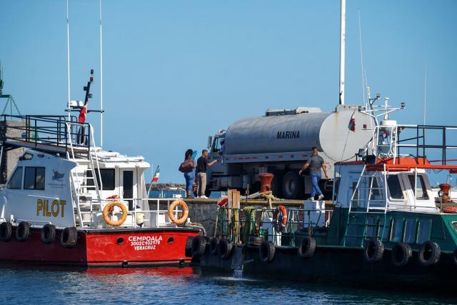 A naval supplies truck arrives at Veracruz port to load the Isla Holbox (BAL-02) vessel belonging to the Mexican Navy (SEMAR), intended for humanitarian aid, in Veracruz, Mexico, on February 6, 2026. Mexico will ship humanitarian aid to Cuba in the coming days while continuing to negotiate with Washington on the possibility of circumventing a US oil siege, President Claudia Sheinbaum said on February 6. (Photo by Victoria Razo / AFP)