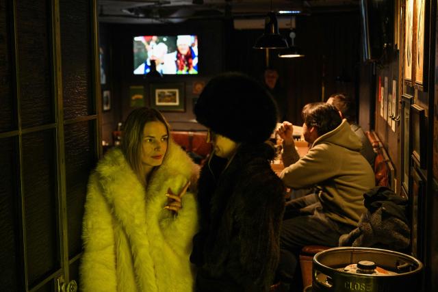 People gather at a bar that is showing the live TV broadcast of the Milano Cortina 2026 Winter Olympic Games opening ceremony in central Moscow, on February 6, 2026. (Photo by HECTOR RETAMAL / AFP)