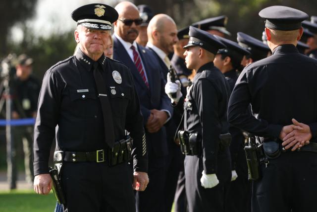 Los Angeles Police Department (LAPD) Chief Jim McDonnell (L) inspects recruits from class 8-25 during their graduation ceremony at the Los Angeles Police Academy in Los Angeles, California on February 6, 2026. The Los Angeles Police Academy holds a graduation ceremony for 26 recruit officers, including 24 for the LAPD, one for the Los Angeles Airport Police and one for the Los Angeles Port Police. (Photo by Patrick T. Fallon / AFP)