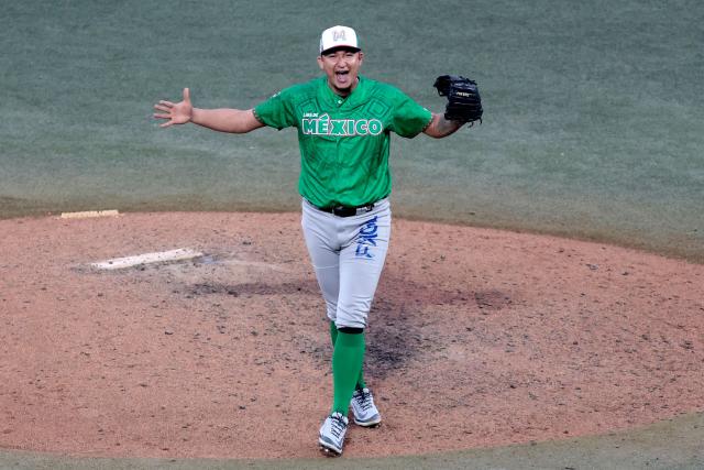 Tomateros de Culiacan's #20 Guadalupe Chavez celebrates at the end of the ninth inning of the Caribbean Series baseball tournament semi-final game between Mexico's Tomateros de Culiacan and Dominican Republic's Leones del Escogido at the Panamerican Stadium in Jalisco, Mexico, on February 6, 2026. (Photo by Ulises Ruiz / AFP)