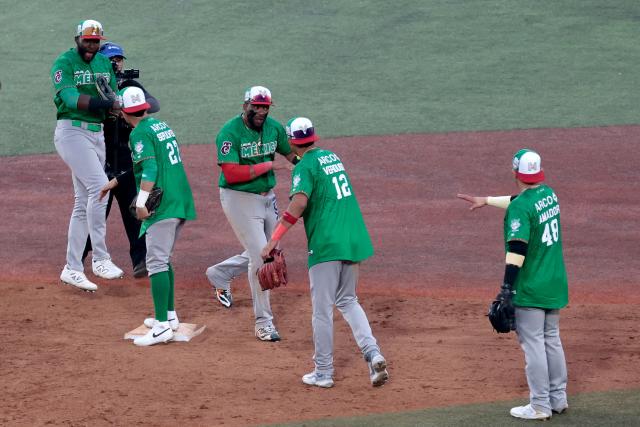 Players Tomateros de Culiacan celebrate at the end of the ninth inning of the Caribbean Series baseball tournament semi-final game between Mexico's Tomateros de Culiacan and Dominican Republic's Leones del Escogido at the Panamerican Stadium in Jalisco, Mexico, on February 6, 2026. (Photo by Ulises Ruiz / AFP)