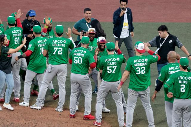 Players Tomateros de Culiacan celebrate at the end of the ninth inning of the Caribbean Series baseball tournament semi-final game between Mexico's Tomateros de Culiacan and Dominican Republic's Leones del Escogido at the Panamerican Stadium in Jalisco, Mexico, on February 6, 2026. (Photo by Ulises Ruiz / AFP)