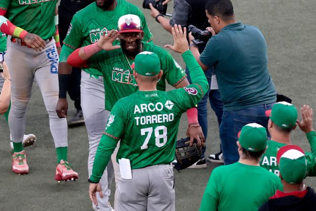 Players Tomateros de Culiacan celebrate at the end of the ninth inning of the Caribbean Series baseball tournament semi-final game between Mexico's Tomateros de Culiacan and Dominican Republic's Leones del Escogido at the Panamerican Stadium in Jalisco, Mexico, on February 6, 2026. (Photo by Ulises Ruiz / AFP)