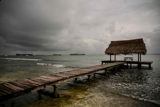 Cargo ships sail from Fort Sherman, located at the Atlantic entrance of the Panama Canal, in Colon province, Panama, on February 6, 2026. (Photo by MARTIN BERNETTI / AFP)