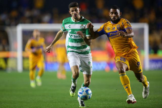 Santos' Argetine forward #09 Lucas di Yorio and Tigres' Brazilian defender #28 Joaquim Henrique fight for the ball during the Liga MX Clausura football match between Tigres and Santos Laguna at the University Stadium (UANL) in San Nicolas de los Garza, Mexico, on February 6, 2026. (Photo by Julio Cesar AGUILAR / AFP)