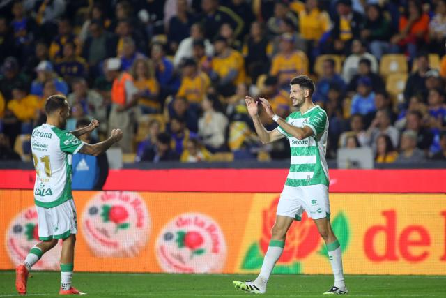 Santos' Argetine forward #09 Lucas di Yorio (R) celebrates with teammate Spanish midfielder #21 Fran Villalba after scoring the opening goal during the Liga MX Clausura football match between Tigres and Santos Laguna at the University Stadium (UANL) in San Nicolas de los Garza, Mexico, on February 6, 2026. (Photo by Julio Cesar AGUILAR / AFP)