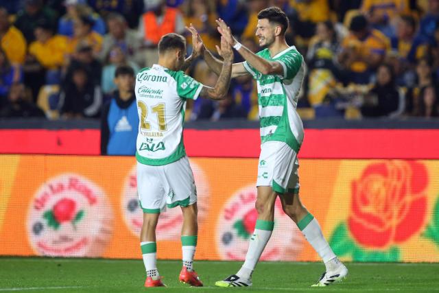 Santos' Argetine forward #09 Lucas di Yorio (R) celebrates with teammate Spanish midfielder #21 Fran Villalba after scoring the opening goal during the Liga MX Clausura football match between Tigres and Santos Laguna at the University Stadium (UANL) in San Nicolas de los Garza, Mexico, on February 6, 2026. (Photo by Julio Cesar AGUILAR / AFP)