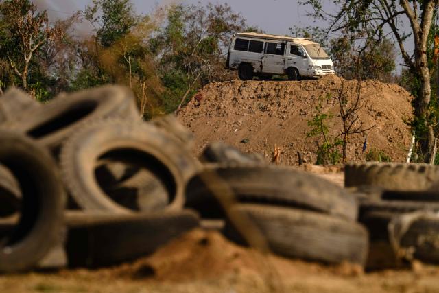 A damaged vehicle is seen on a mound of earth during a military organised tour near Ban Nong Chan, an area now controlled by the Thai forces following the border conflict with Cambodia on February 5, 2026. A sign hanging from a rusty ice-green shipping container installed by Thai forces on what they say is the border with Cambodia proclaims: "Cambodian citizens are strictly prohibited from entering this area." (Photo by ANTHONY WALLACE / AFP) / To go with 'THAILAND-CAMBODIA-CONFLICT-BORDER,REPORTAGE' by Suy SE and Montira RUNGJIRAJITTRANON