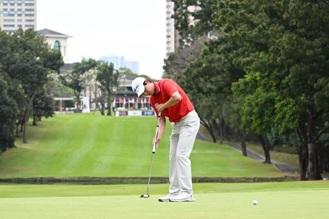 South Korea's Wang Jeung-hun putts on the second hole during the third round of the Philippines Golf Championship tournament at the Wack Wack Golf and Country Club in Manila on February 7, 2026. (Photo by Ted ALJIBE / AFP)