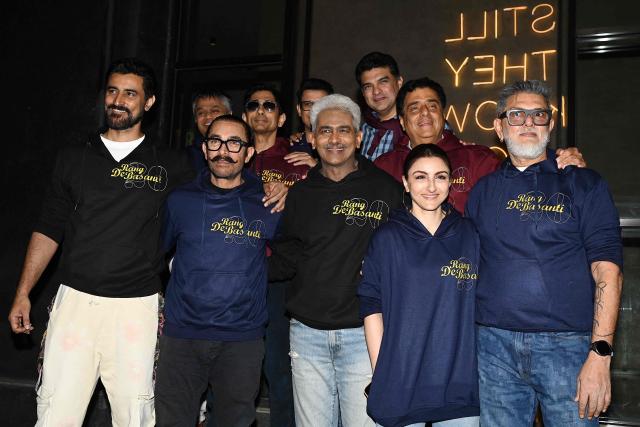 (Front L-R) Bollywood actors Kunal Kapoor, Aamir Khan, Atul Kulkarni, Soha Ali Khan with writer, producer and director Rakeysh Omprakash Mehra attend the special screening of their Indian Hindi-language coming-of-age political action film 'Rang De Basanti' during celebrations to mark its 20th anniversary since release in Mumbai on February 6, 2026. (Photo by Sujit JAISWAL / AFP)