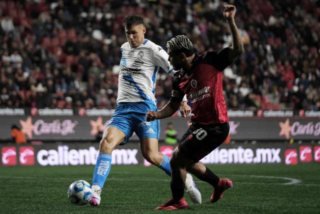 Puebla's Costa Rican defender #04 Juan Pablo Vargas and Tijuana's Venezuelan forward #30 Josef Martinez fight for the ball during the Liga MX Clausura football match between Tijuana and Puebla at the Caliente Stadium in Tijuana, Mexico, on February 6, 2026. (Photo by Guillermo Arias / AFP)