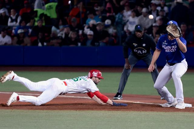 Charros de Jalisco's #26 Michael Wielansky slides to first ball as Cangrejeros de Santurce's #18 Yohandy Morales cathces the ball in the third inning of the Caribbean Series baseball tournament semi-final game between Mexico's Charros de Jalisco and Puerto Rico's Cangrejeros de Santurce at the Panamerican Stadium in Jalisco, Mexico, on February 6, 2026. (Photo by Ulises Ruiz / AFP)