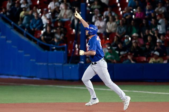 Cangrejeros de Santurce's #18 Yohandy Morales runs to home after hitting a home run in the first inning of the Caribbean Series baseball tournament semi-final game between Mexico's Charros de Jalisco and Puerto Rico's Cangrejeros de Santurce at the Panamerican Stadium in Jalisco, Mexico, on February 6, 2026. (Photo by Ulises Ruiz / AFP)