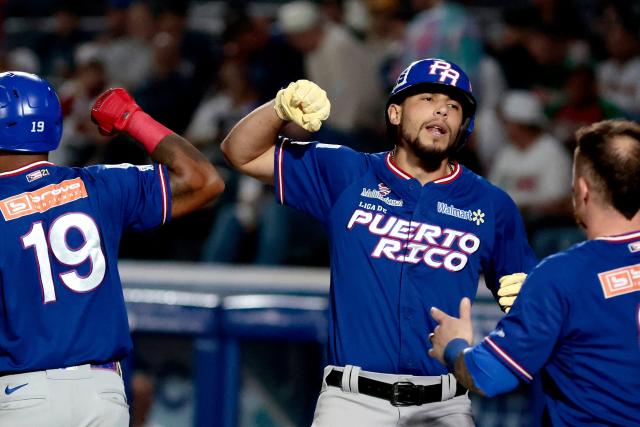 Cangrejeros de Santurce's #18 Yohandy Morales celebrates with teammates after hitting a home run in the first inning of the Caribbean Series baseball tournament semi-final game between Mexico's Charros de Jalisco and Puerto Rico's Cangrejeros de Santurce at the Panamerican Stadium in Jalisco, Mexico, on February 6, 2026. (Photo by Ulises Ruiz / AFP)