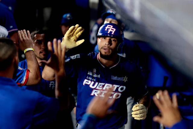 Cangrejeros de Santurce's #18 Yohandy Morales celebrates with teammates after hitting a home run in the first inning of the Caribbean Series baseball tournament semi-final game between Mexico's Charros de Jalisco and Puerto Rico's Cangrejeros de Santurce at the Panamerican Stadium in Jalisco, Mexico, on February 6, 2026. (Photo by Ulises Ruiz / AFP)