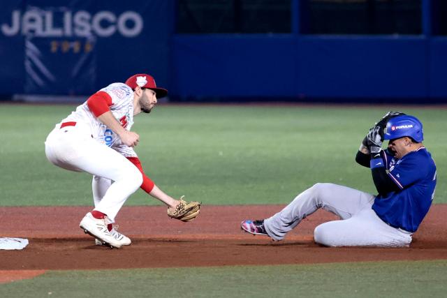 Cangrejeros de Santurce's #24 Isan Diaz slides to second base in front of Charros de Jalisco's #26 Michael Wielansky in the first inning of the Caribbean Series baseball tournament semi-final game between Mexico's Charros de Jalisco and Puerto Rico's Cangrejeros de Santurce at the Panamerican Stadium in Jalisco, Mexico, on February 6, 2026. (Photo by Ulises Ruiz / AFP)
