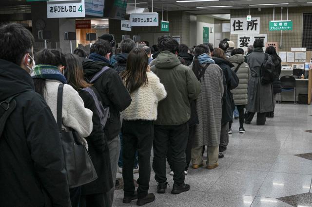 People queue up at an early voting station for the House of Representatives election set up at a ward office in Kawasaki, Kanagawa prefecture on February 7, 2026. (Photo by Yuichi YAMAZAKI / AFP)