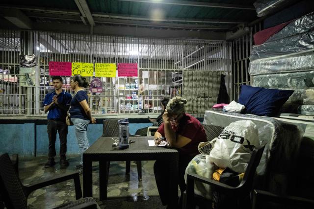 A woman uses her mobile phone as she waits for news of prisoner releases outside El Rodeo I prison in Guatire, Miranda state, some 30 kilometers east of Caracas, on February 6, 2026. Venezuela's parliament chief, a former member of ousted leader Nicolas Maduro's inner circle, on February 6 promised the speedy release of remaining political prisoners during a meeting with their relatives. "By Friday (February 13) at the latest they will all be free," Jorge Rodriguez told prisoners' families outside the notorious Zona 7 detention center in Caracas. (Photo by Maryorin Mendez / AFP)