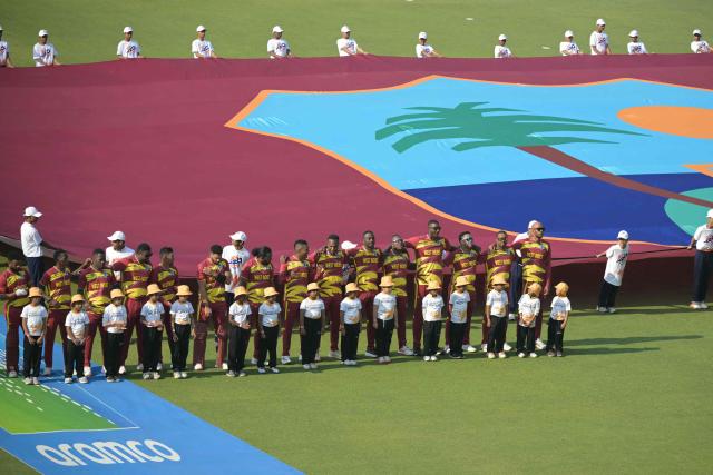 West Indies' players stand during their national anthem at the start of the 2026 ICC Men's T20 Cricket World Cup group stage match between Scotland and West Indies at the Eden Gardens in Kolkata on February 7, 2026. (Photo by Dibyangshu SARKAR / AFP)
