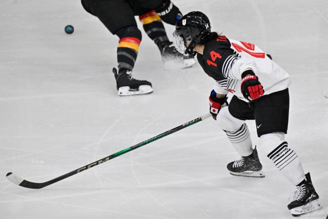 Japan's #14 Haruka Toko vies for the puck during the women's preliminary round Group B Ice Hockey match between Germany and Japan at the Milano Rho Ice Hockey Arena at the Milano Cortina 2026 Winter Olympic Games in Milan, on February 7, 2026. (Photo by Alexander NEMENOV / AFP)