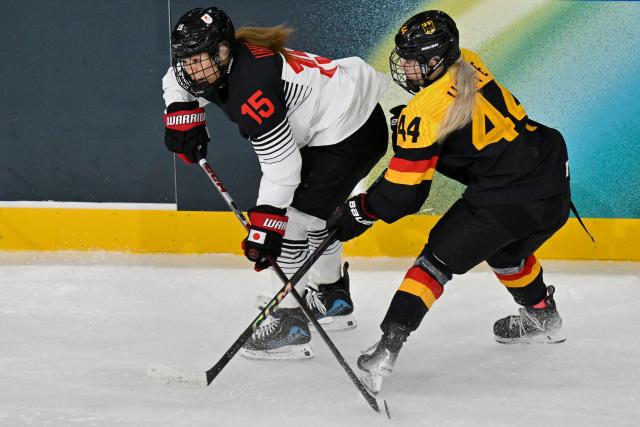 Japan's #15 Rui Ukita and Germany's defender #44 Hanna Hoppe vie for the puck during the women's preliminary round Group B Ice Hockey match between Germany and Japan at the Milano Rho Ice Hockey Arena at the Milano Cortina 2026 Winter Olympic Games in Milan, on February 7, 2026. (Photo by Alexander NEMENOV / AFP)