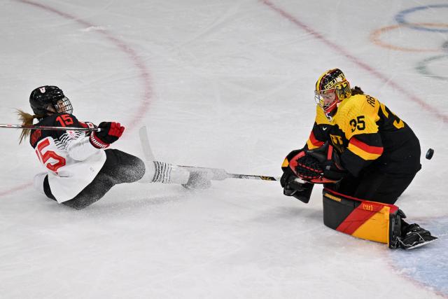 Germany's goalkeeper #35 Sandra Abstreiter defends the goal in front of Japan's #15 Rui Ukita during the women's preliminary round Group B Ice Hockey match between Germany and Japan at the Milano Rho Ice Hockey Arena at the Milano Cortina 2026 Winter Olympic Games in Milan, on February 7, 2026. (Photo by Alexander NEMENOV / AFP)